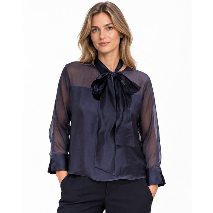 Natan women's navy FLAIR blouse with neck bow and sheer sleeves, front view on model
